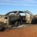 Burned and abandoned car in desert